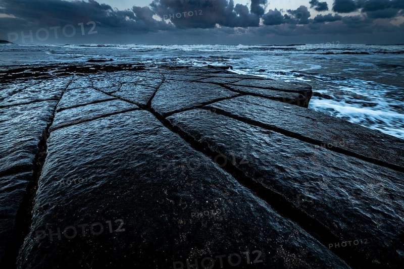 Coast with granite rocks washed by the sea in the evening light