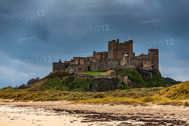 Sandy coast at low tide with Bamburgh Castle