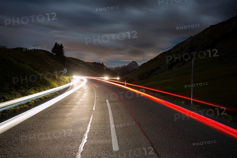 Pass road at night with light streaks from cars on Hochtannbergpass