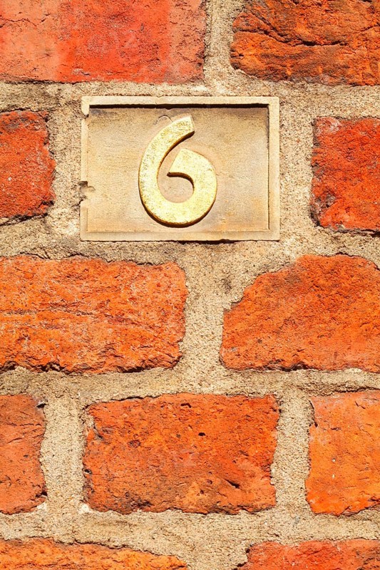 Old golden house number plate