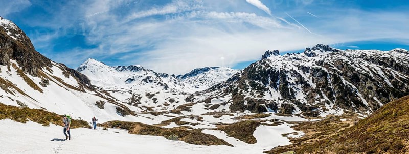 Two hikers walk over snowfield