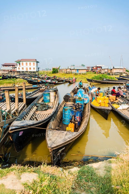 Wooden boats with old oil barrels in the harbor