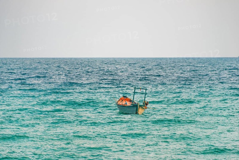 Traditional long-tail boat in turquoise sea