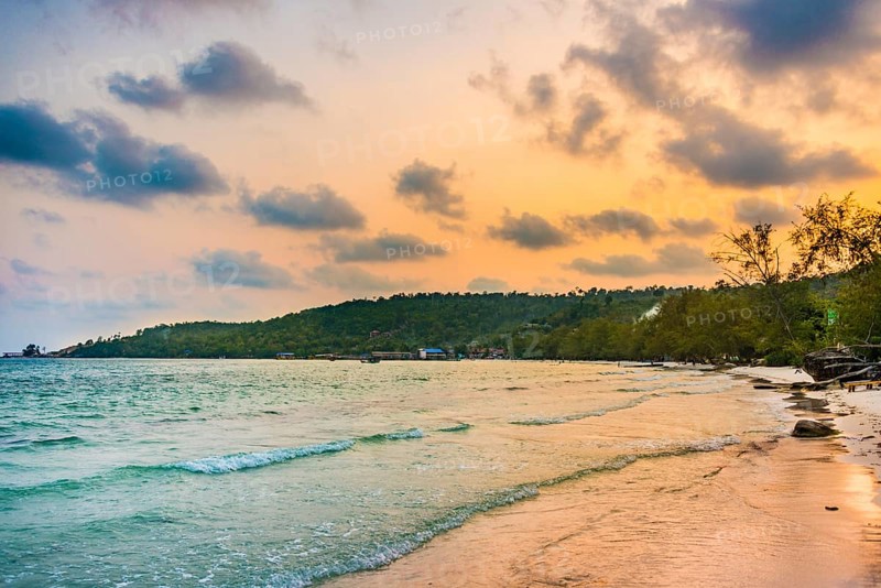 Idyllic sandy beach with turquoise water at sunset