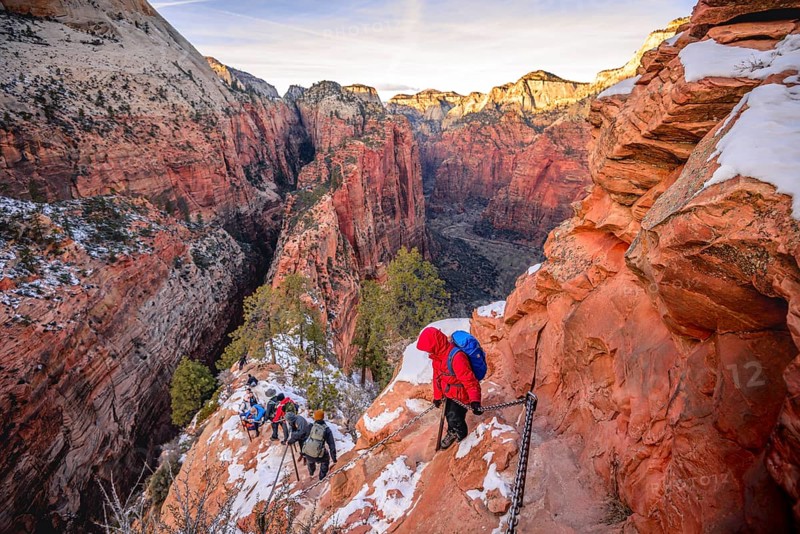 Young woman hikes on the via ferrata descending from Angels Landing