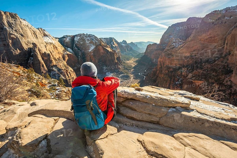 Young woman looking into the distance from Angels Landing to Zion Canyon