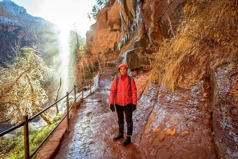 Female hiker in front of waterfall