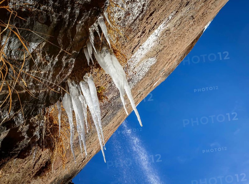 Icicles hanging on rock face