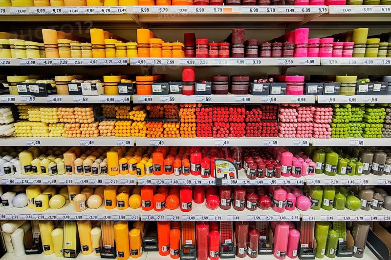 Shelves with coloured candles in supermarkets