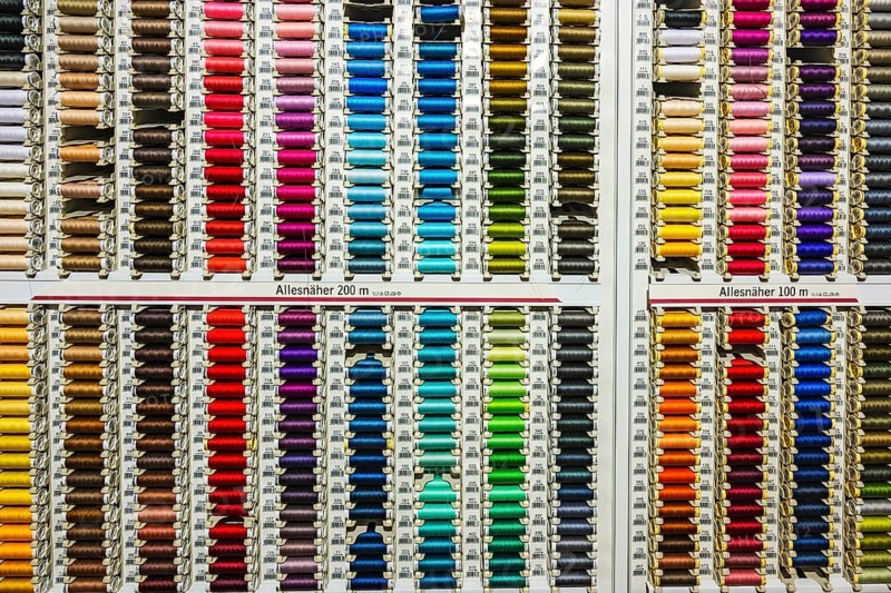 Colorful spools with sewing thread in many colors in a department store