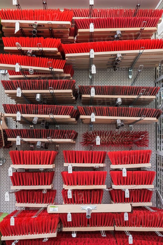 Brooms with plastic bristles in hardware store