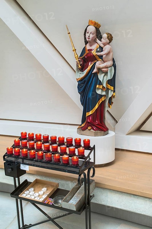 Madonna figure with baby Jesus and sacrificial candles