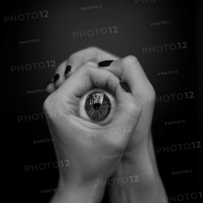 Hands holding artificial eye