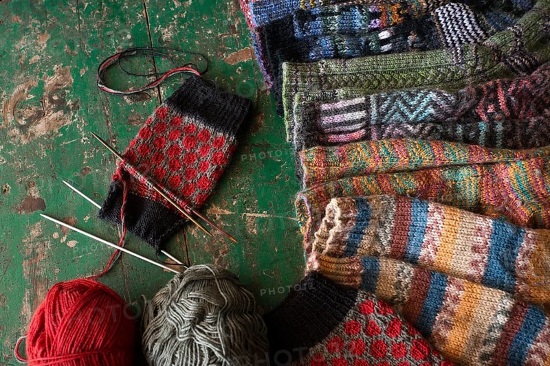 Knitted patterned socks with knitting needle and wool