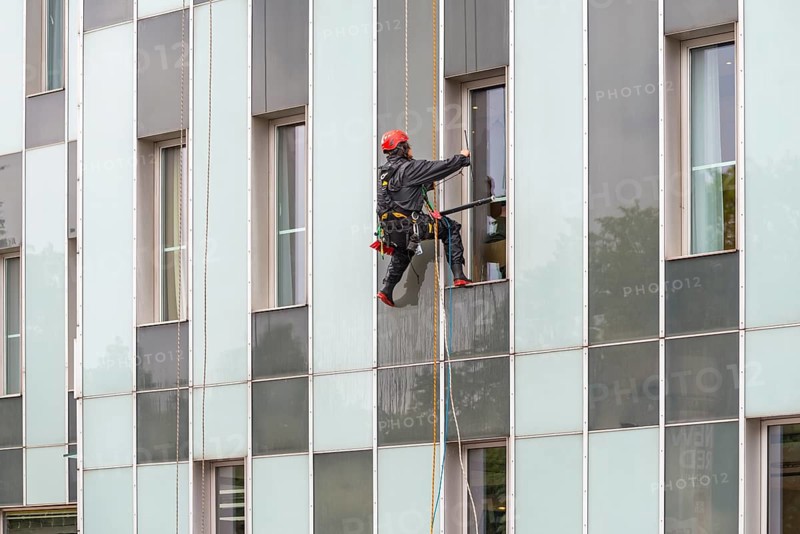 Window cleaner on skyscraper facade