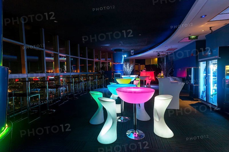Illuminated chairs and tables in a discotheque