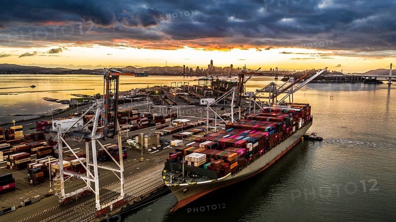 Cargo ship at sunset in the Port of Oakland