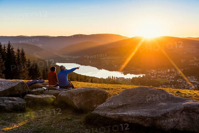 Older couple at Hochfirst with view to Titisee and Feldberg at sunset