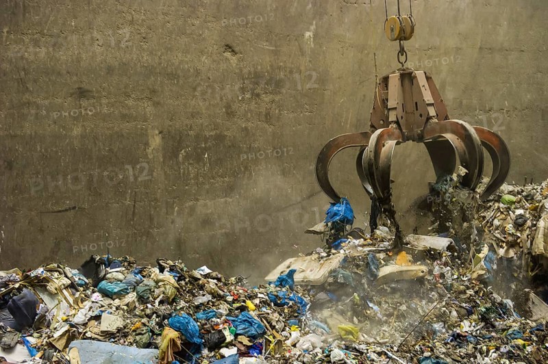 A crane transports waste in a waste-to-energy plant