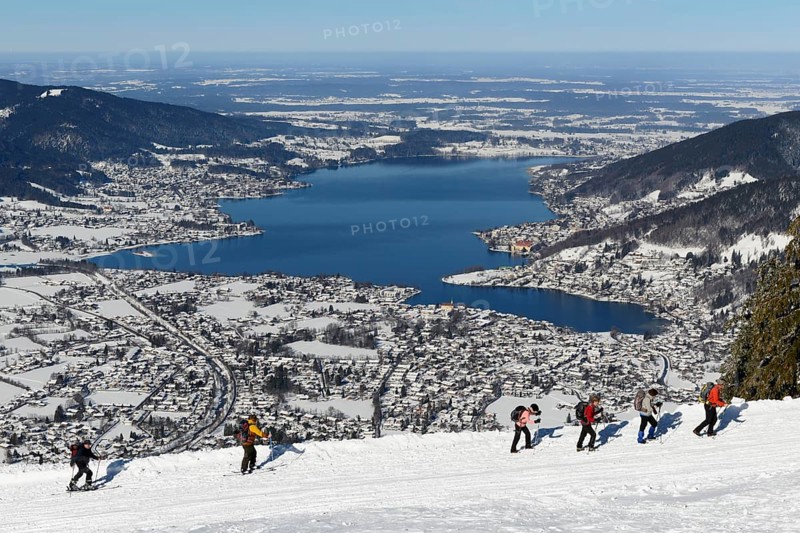 Hikers and ski tourers climb the Wallberg in winter