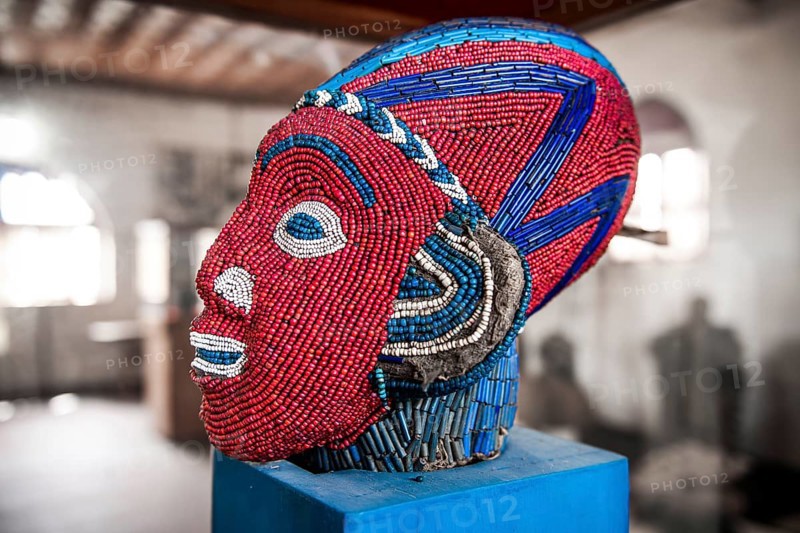 Sculpture decorated with glass and ceramic beads
