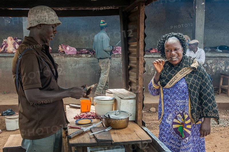 Woman eating grilled meat at street stand