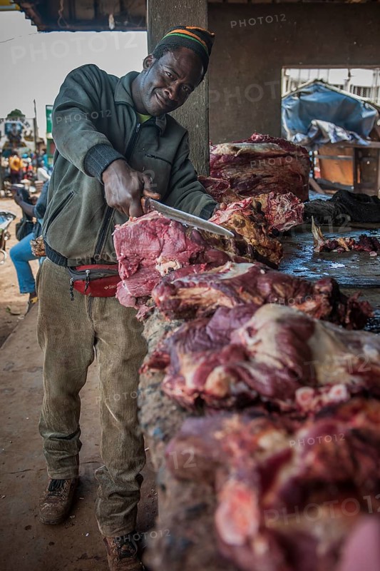 Butcher with meat at market