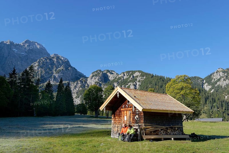 Hikers resting wooden hut