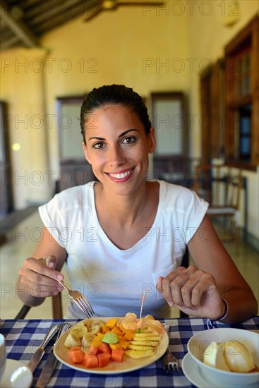 Young woman having breakfast in a hotel