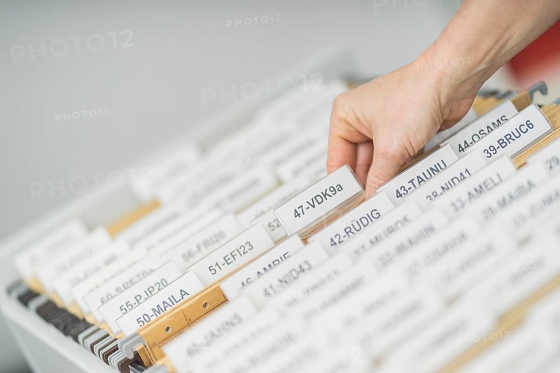 File is taken by person from file cabinet