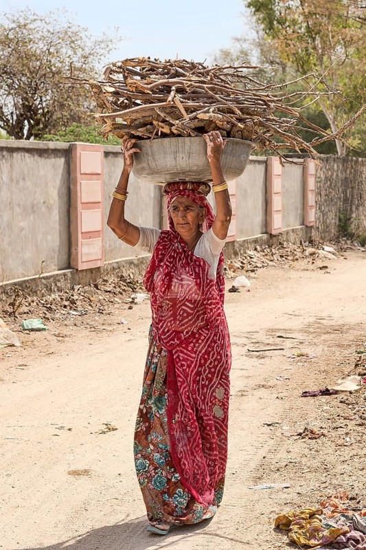 Old woman carrying firewood on head