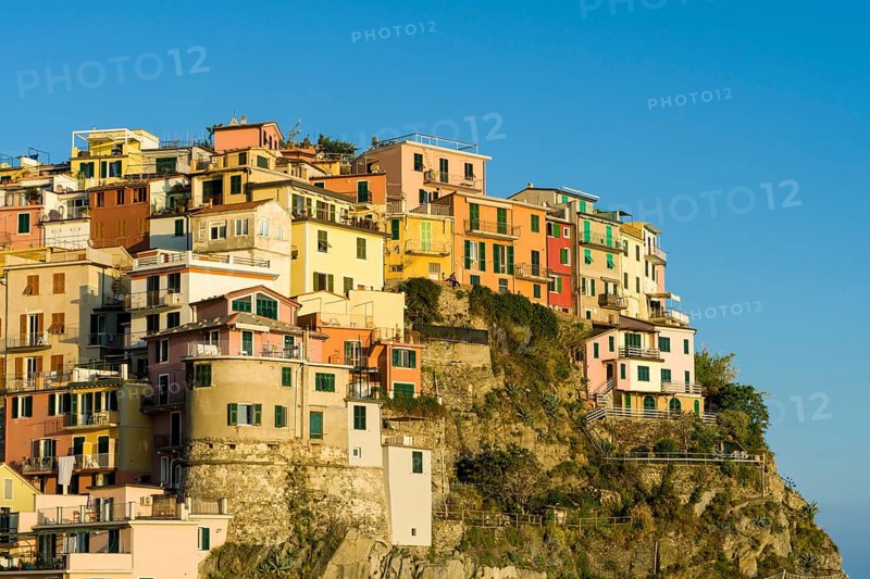 Colorful houses of Manarola town crammed on a hill on the coast of the Mediterranean Sea
