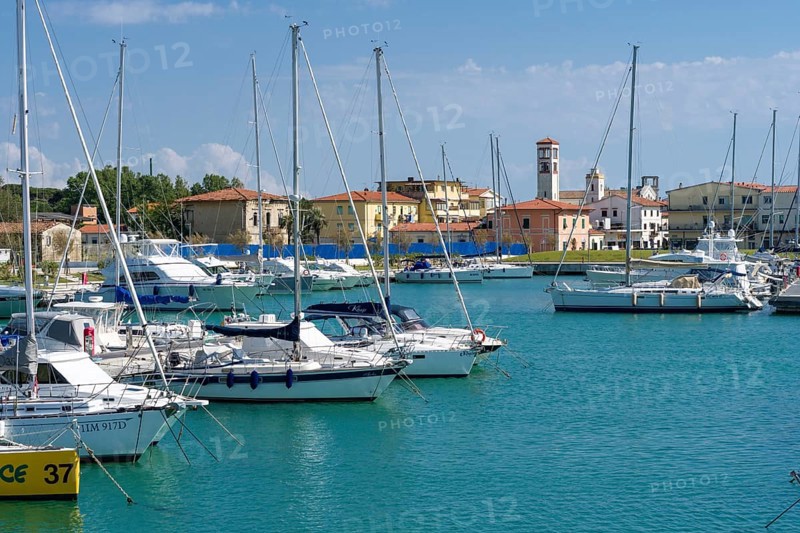Sailing and motor boats are anchored in the harbour