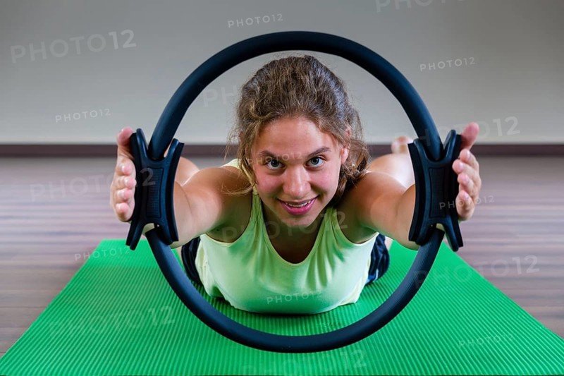 A young woman is training Pilates