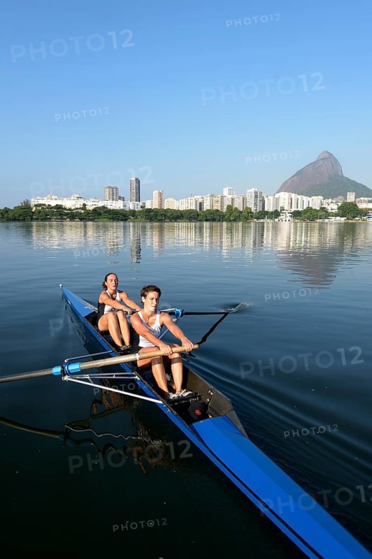 Two young women participating in early morning rowing training in the Lagoa Rodrigo de Freitas Lagoon