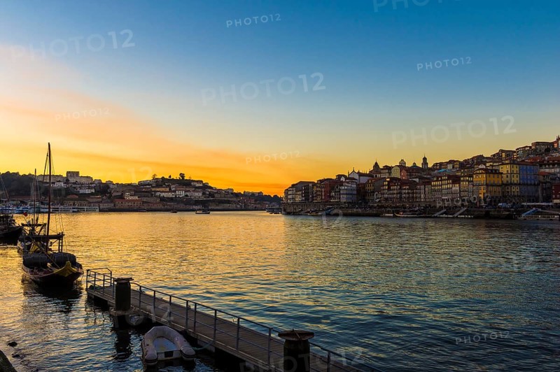 Sunset over Douro river with Rabelo boat and Ribeira district