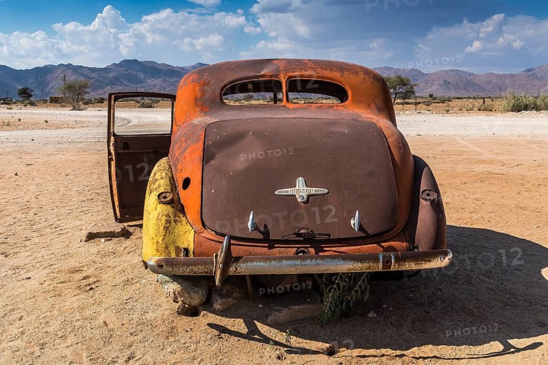 Old car wreck in sand