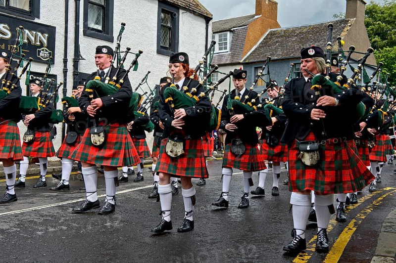 Bagpipers playing instruments in a parade
