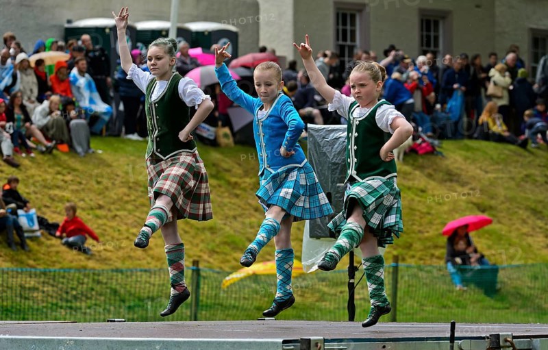 Girls dancing in kilts at a folk dance competition