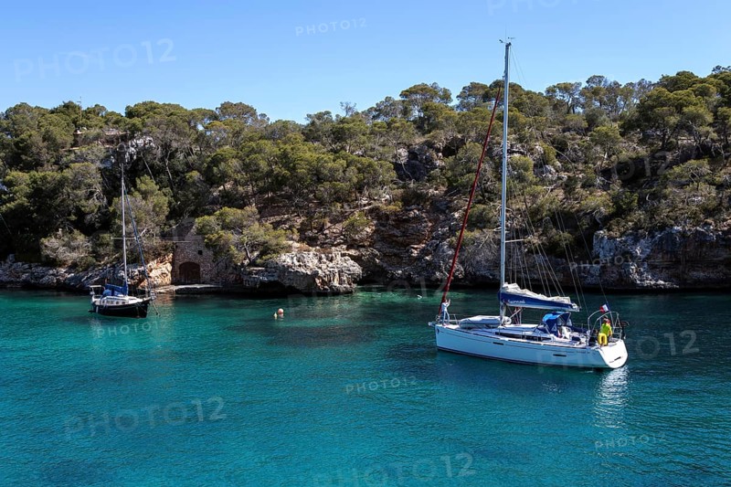 Sailboats anchor in the bay of Cala Figuera