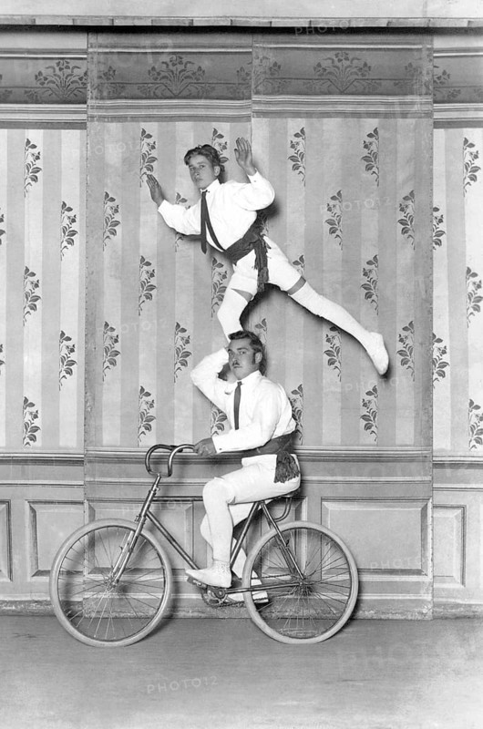 Two acrobats on a bicycle