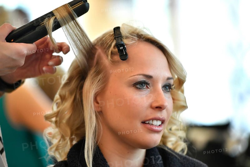 Young woman being styled at the hair salon