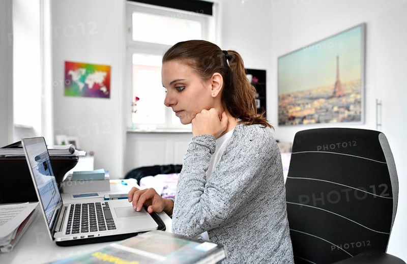 Student at desk with a laptop
