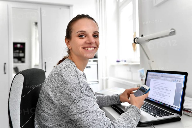 Student with smartphone and laptop