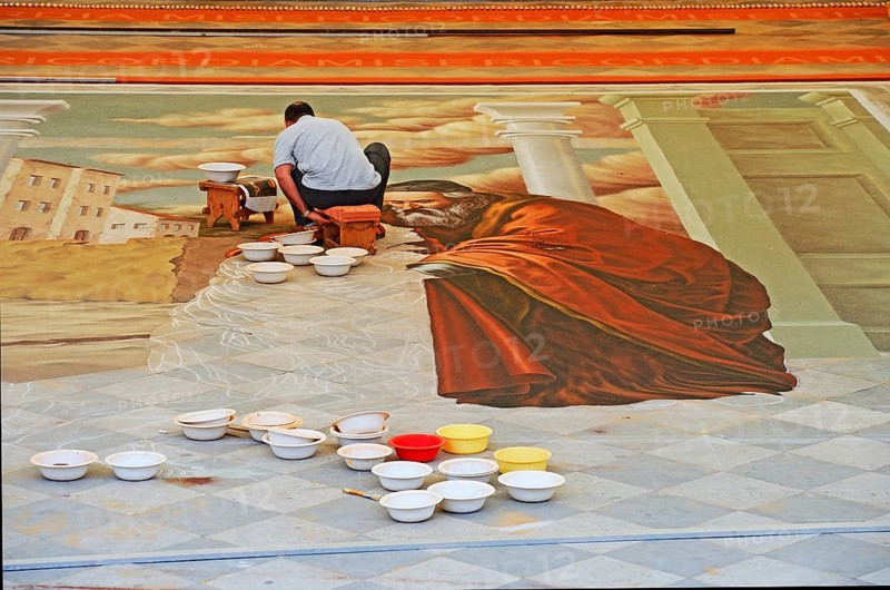 Artist creating image using coloured sand