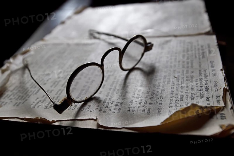 Old spectacles on historic book