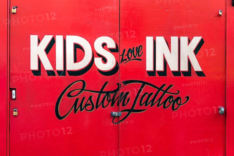 Painted sign for Kids Love Ink tattoo parlor