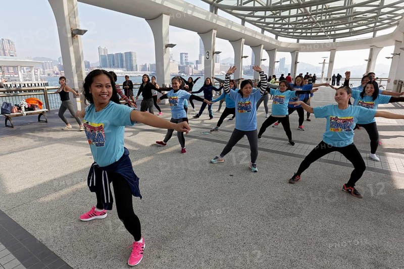 Southeast Asian women dancing Zumba on pier