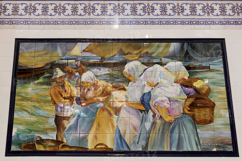 Fishermen and women by the sea