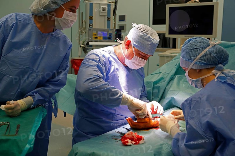 Surgeons during surgery in the operating theatre